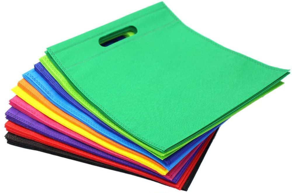 Stack of colourful D-cut non-woven shopping bags by PRINT POINT